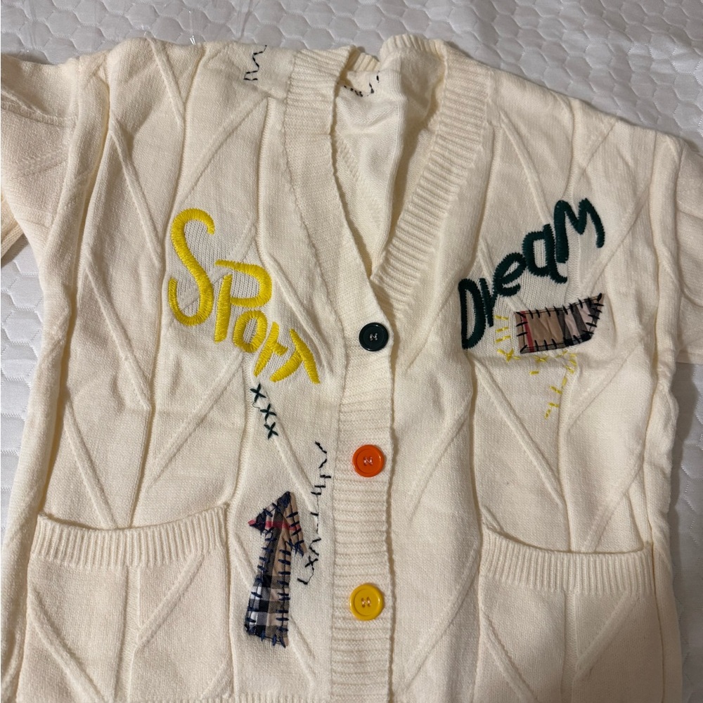 Cream Cardigan with Colorful Buttons and Graphic Text